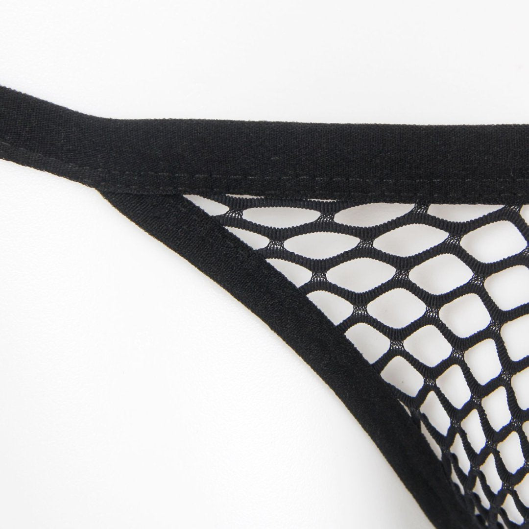 Close-up of black men's fishnet thong with large mesh pattern and elastic waistband